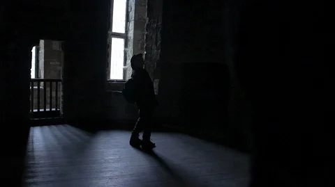 Figure in the shadow's explores medieval Castle fort Stock Footage 128665719