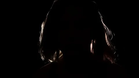 Figure sits in the dark Stock Footage 122357108