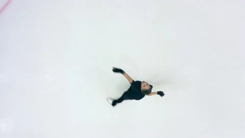 Figure skater is doing skating elements in a top view Stock Footage 162053926