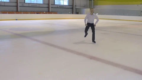 Figure Skater Performs Exercises On the Ice Stock Footage 69999677