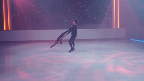 Figure skaters pair on ice performs stationary rotational support,prohibited Stock Footage 180640632