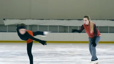 Figure skating girl doing exercise with coach Видео 102331800