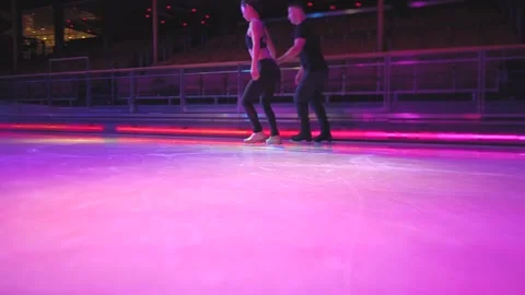Figure skating slide element on ice rink by skaters couple Stock Footage 137466741