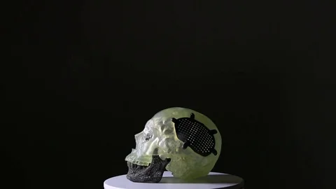 A figure of a skull printed with 3D technology on a black background. Stock Footage 81848998