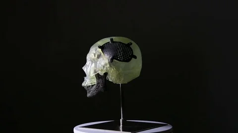 A figure of a skull printed with 3D technology on a black background. Stock Footage 81849063