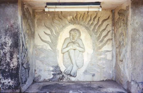 Figure surrounded by flames bas-relief Stock Photos