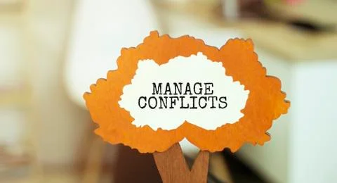 Figure of a tree with text MANAGE CONFLICTS inside the foliage. Business conc Stock Photos