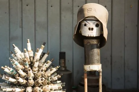 Figure welded from an old car piston an Old used car engine piston close-up. Stock Photos