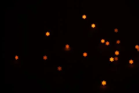 Figured boke in the form of a snowflake on a dark background. Stock Photos