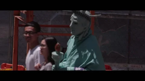 Figured dressed as statue of liberty dancing Stock Footage 57216943