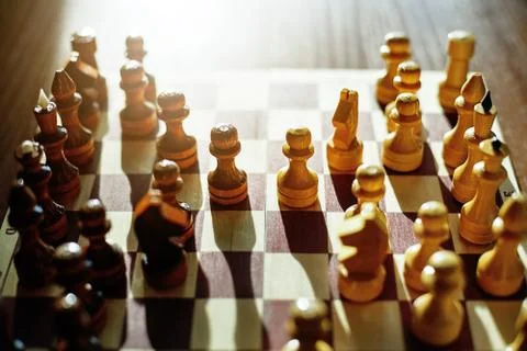The figures are placed on a chessboard. Beginning of the game. Stock Photos