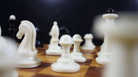Figures on a chessboard in motion Stock Footage 77279030