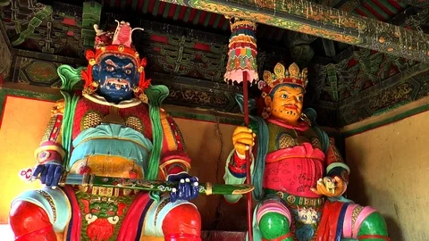Figures of the guardian gods of the cardinal points in a Buddhist monastery. Stock Footage 121876501