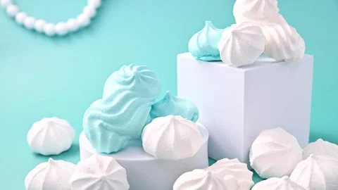 Figures of meringue of different colors on a blue background. Traditional Italia Stock Footage 147333473