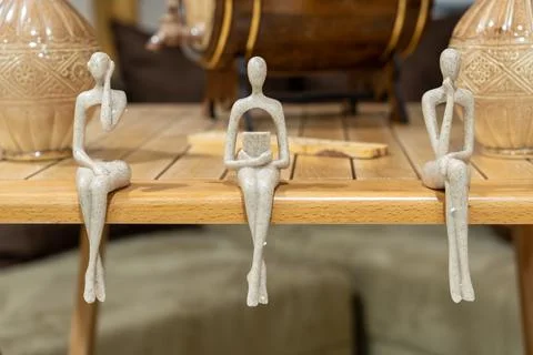 Figures  sitting on the edge of the table Stock Photos