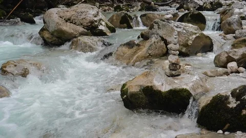 Figures of stones in the middle of a stormy stream, slow motion Stock Footage 115421037
