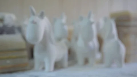 Figures of unicorns stand on the desktop in the workshop Stock Footage 102258463