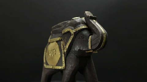 Figurine of an elephant on a black background Stock Footage 129697058