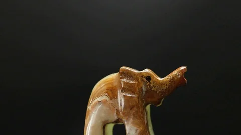 Figurine of an elephant on a black background Stock Footage 129697668