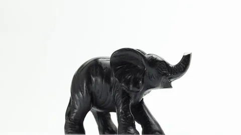 Figurine of an elephant rotates on a white background Stock Footage 129697135