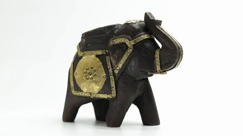 Figurine of an elephant rotates on a white background Stock Footage 129697854