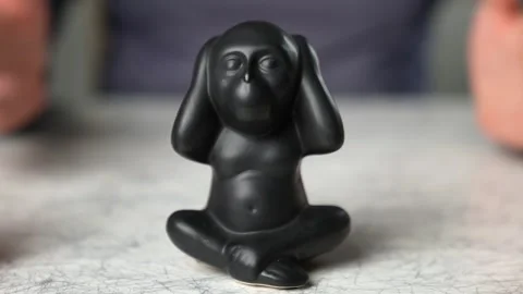 Figurine Hear No Evil Monkey (Wise monkey) with a blurred background of an expla Video stock 242801096