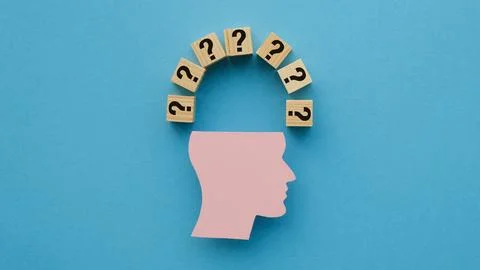 A figurine of a human head and a question mark on wooden cubes, Decision-ma.. Stock Photos