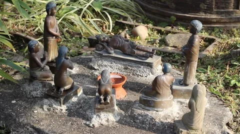 Figurine of the sleeping Buddha and his disciples Stock Footage 59135647