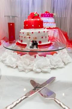Figurines on bottom of wedding cake Stock Photos