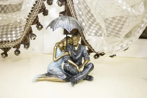 Figurines of lovers on the window Stock Photos