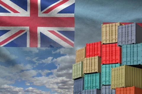 Fiji flag and big stack of shipping cargo containers in docks with sky Foto stock