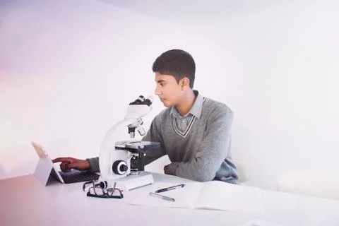 Fiji Indian boy using digital tablet and microscope Stock Photos