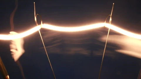 Filament of a electric light bulb going on and off. Stock Footage 706281