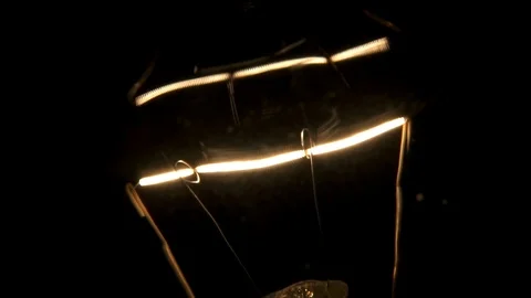 Filament flickering. Black background macro shot 4k Stock Footage 89648721