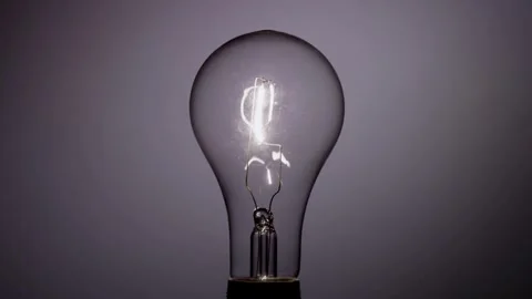 Filament glows bright then flickers and fades to black Stock Footage 329657323