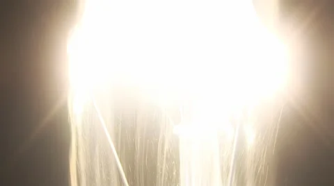 Filament light bulb is dissolved in the plasma swirling, sparkling beauty. Stock Footage 43338532