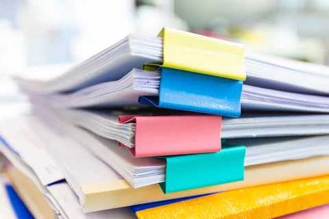 File folder and Stack of business report paper file on the table Photos