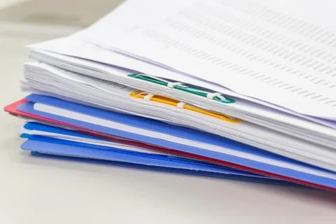 File folder and Stack of business report paper file on the table Photos