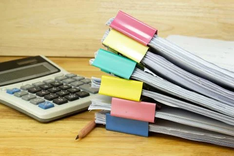 File folder and Stack of business report paper file with Calculator Photos