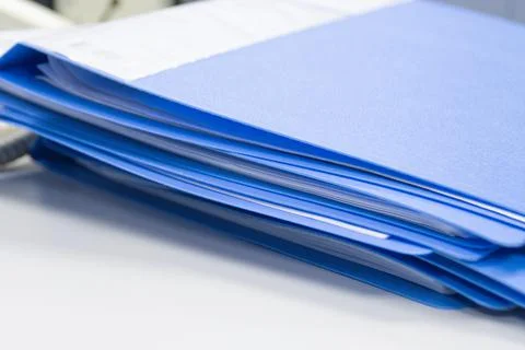 File folder and Stack of business report paper file on the table Photos