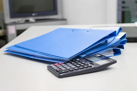 File folder with documents and  Calculator on table in meeting room Stock Photos