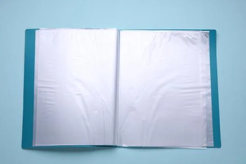 File folder with punched pockets and paper sheets on turquoise background, .. Stock Photos