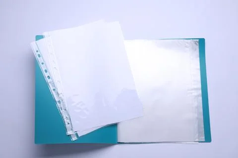 File folder with punched pockets and paper sheets isolated on white, top view Stock Photos