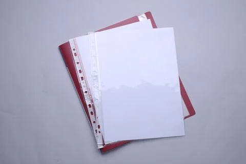 File folder with punched pockets and paper sheets on light grey background,.. Stock Photos