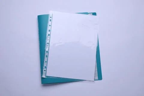 File folder with punched pockets and paper sheets isolated on white, top view Stock Photos