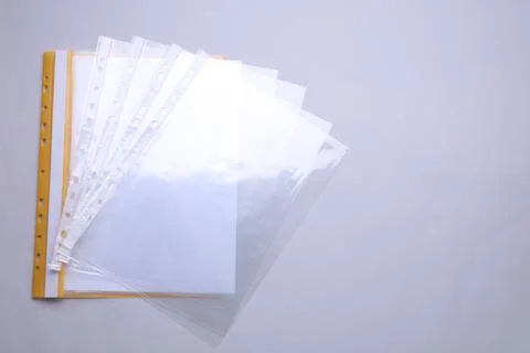 File folder with punched pockets and paper sheets on light grey background,.. Stock Photos