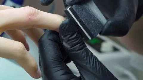 File for grinding. Nail treatment with a buffer block for grinding Stock Photos