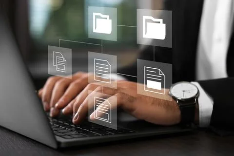 File system. Businessman using laptop at table, closeup. Scheme with folder.. Stock Photos