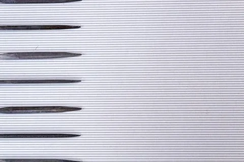 File tool for processing metal and wood lying on a light background. Stock Photos