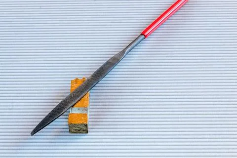 File tool for processing metal and wood lying on a light background. Stock Photos